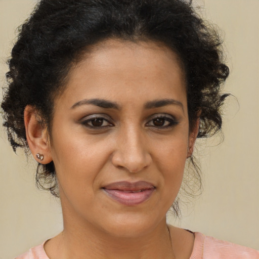 Joyful latino adult female with short  brown hair and brown eyes
