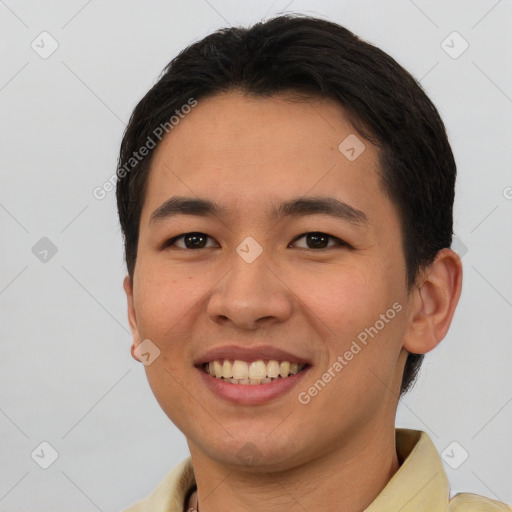 Joyful asian young-adult male with short  brown hair and brown eyes