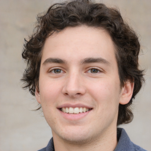 Joyful white young-adult male with medium  brown hair and brown eyes