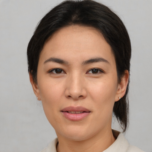 Joyful asian young-adult female with medium  brown hair and brown eyes