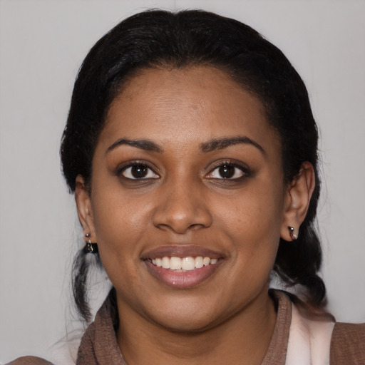 Joyful latino young-adult female with medium  black hair and brown eyes