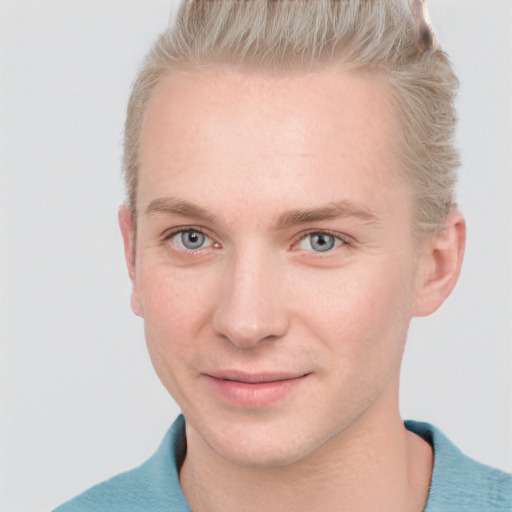 Joyful white young-adult male with short  brown hair and blue eyes