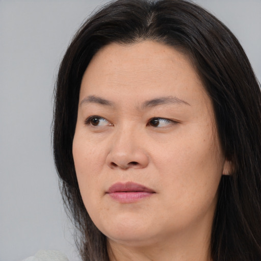 Joyful asian adult female with long  brown hair and brown eyes