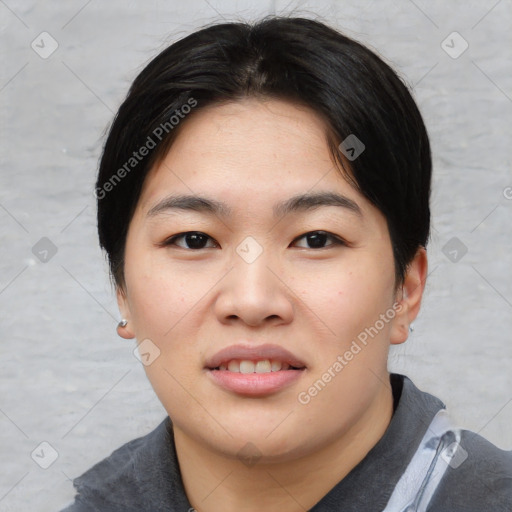 Joyful asian young-adult female with short  black hair and brown eyes