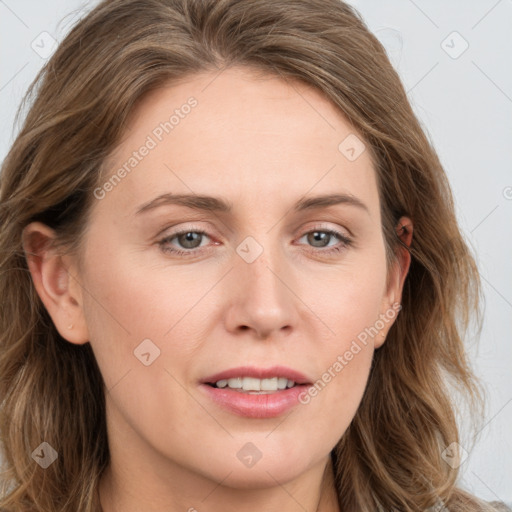 Joyful white young-adult female with long  brown hair and blue eyes