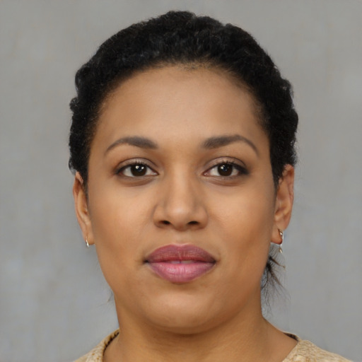 Joyful black young-adult female with short  brown hair and brown eyes