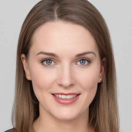 Joyful white young-adult female with long  brown hair and grey eyes