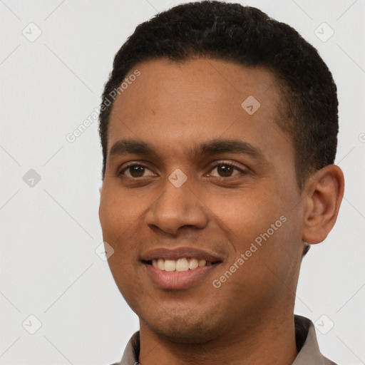 Joyful latino young-adult male with short  black hair and brown eyes