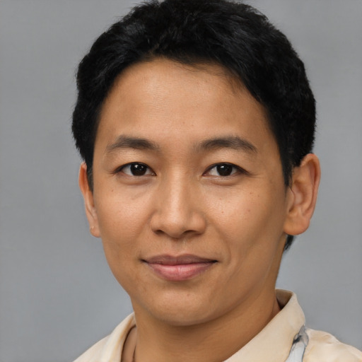 Joyful asian young-adult male with short  black hair and brown eyes