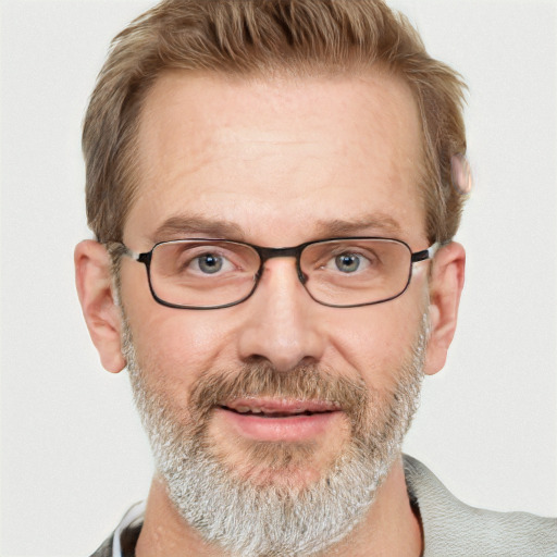 Joyful white middle-aged male with short  brown hair and blue eyes