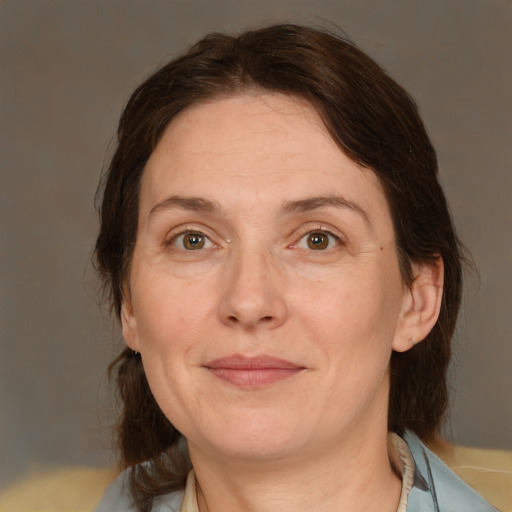 Joyful white adult female with medium  brown hair and grey eyes