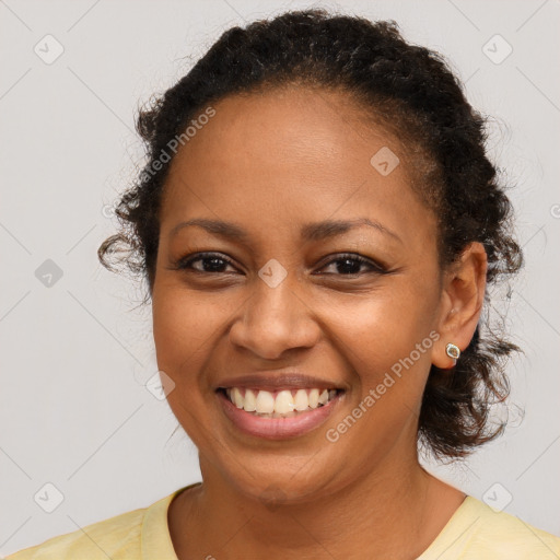 Joyful black young-adult female with medium  brown hair and brown eyes