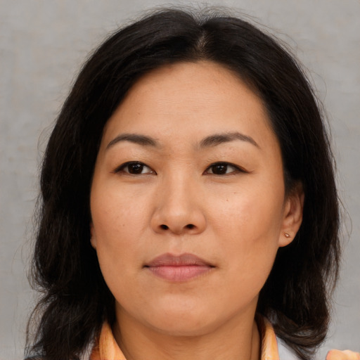 Joyful asian adult female with medium  brown hair and brown eyes