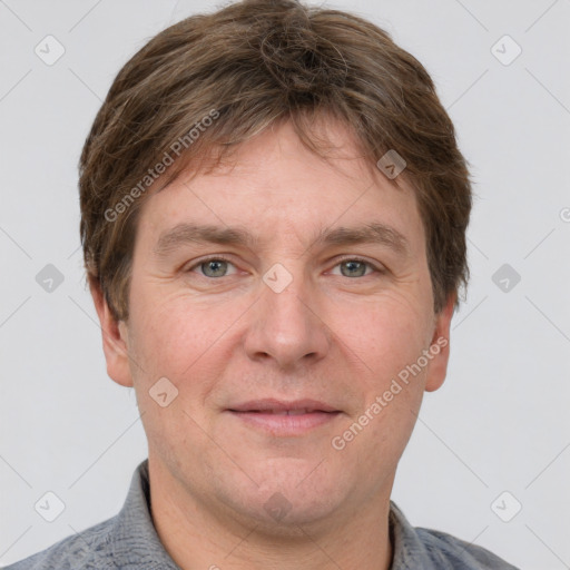 Joyful white adult male with short  brown hair and grey eyes