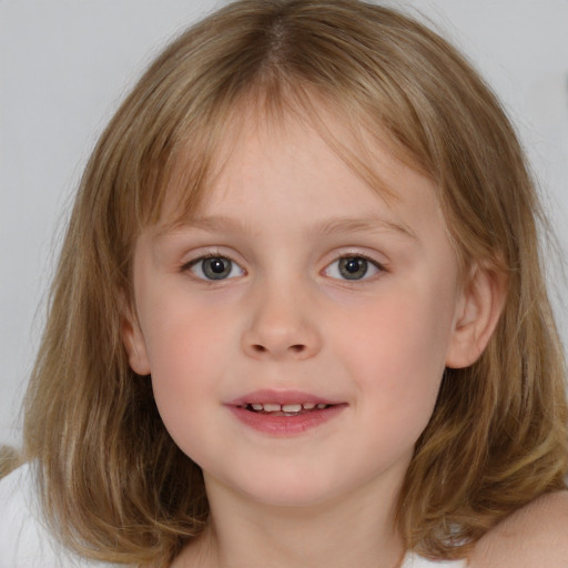 Joyful white child female with medium  brown hair and grey eyes