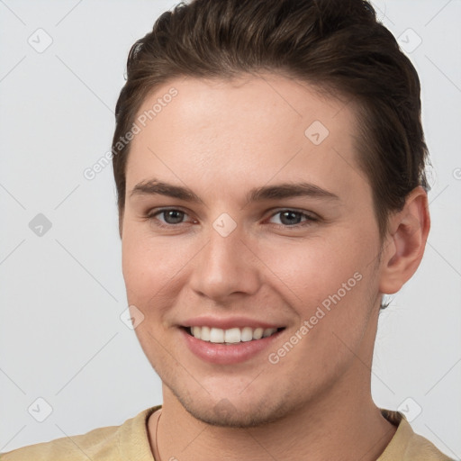 Joyful white young-adult female with short  brown hair and grey eyes