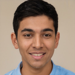 Joyful white young-adult male with short  black hair and brown eyes