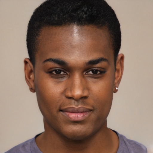 Joyful black young-adult male with short  brown hair and brown eyes