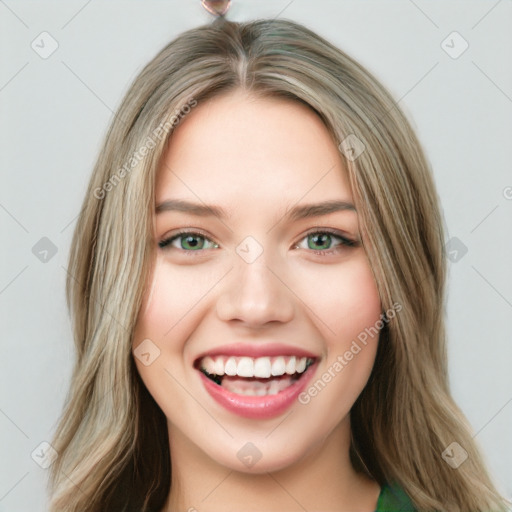 Joyful white young-adult female with long  brown hair and green eyes