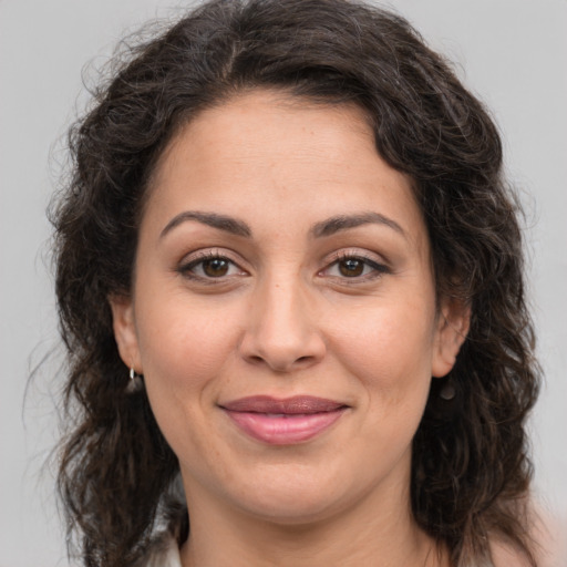 Joyful white adult female with long  brown hair and brown eyes