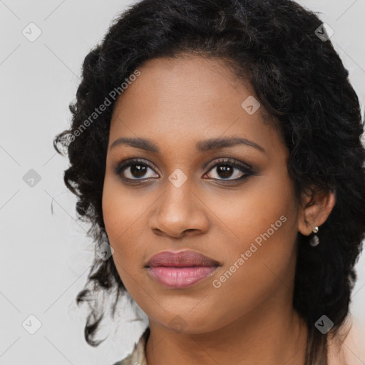 Joyful black young-adult female with long  black hair and brown eyes