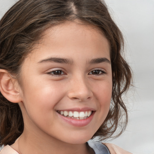 Joyful white child female with medium  brown hair and brown eyes