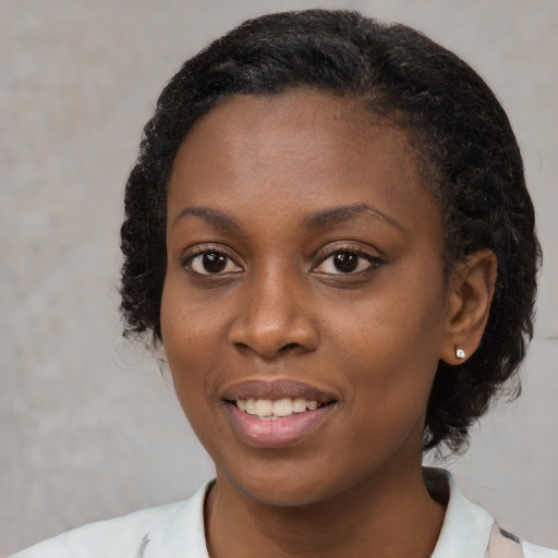 Joyful black young-adult female with medium  black hair and brown eyes