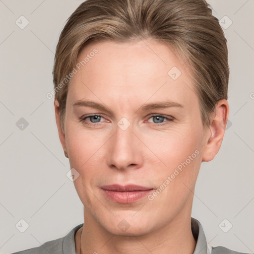 Joyful white young-adult female with short  brown hair and grey eyes