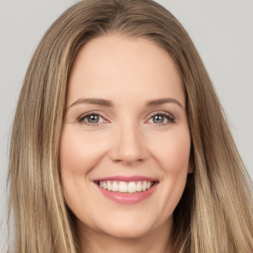 Joyful white young-adult female with long  brown hair and brown eyes