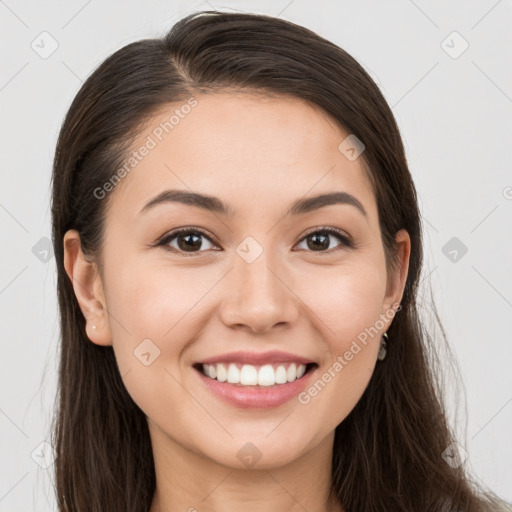 Joyful white young-adult female with long  brown hair and brown eyes