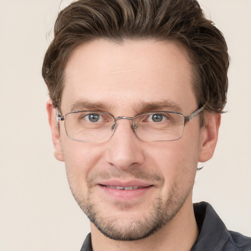 Joyful white adult male with short  brown hair and grey eyes