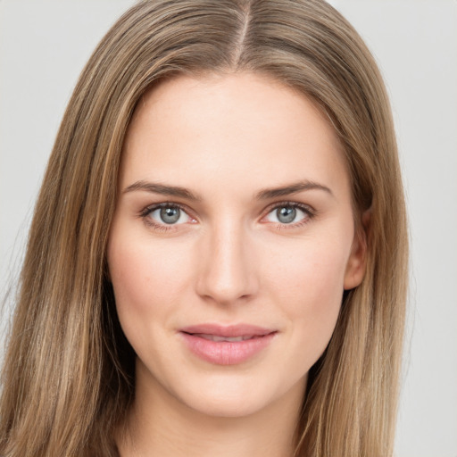 Joyful white young-adult female with long  brown hair and green eyes