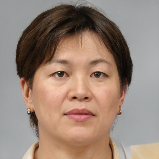 Joyful white adult female with medium  brown hair and brown eyes