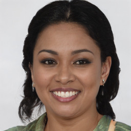 Joyful latino young-adult female with medium  brown hair and brown eyes