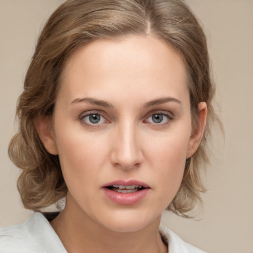 Joyful white young-adult female with medium  brown hair and blue eyes