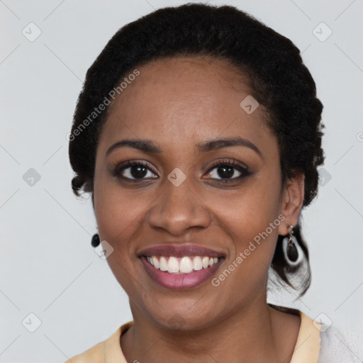 Joyful black young-adult female with short  black hair and brown eyes