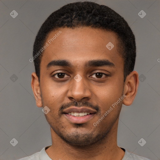 Joyful black young-adult male with short  black hair and brown eyes