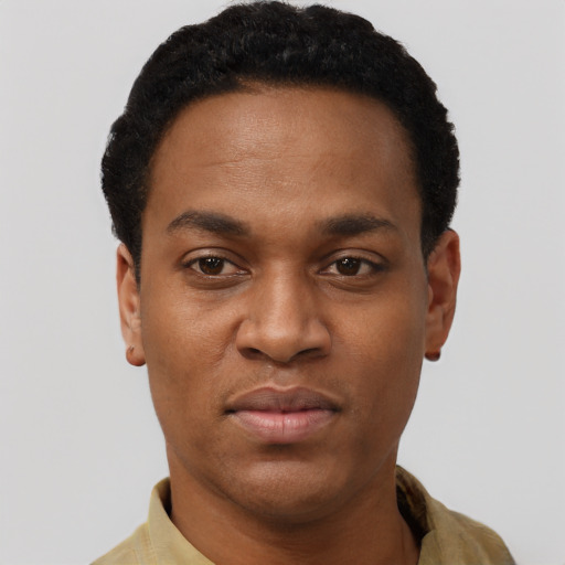 Joyful black young-adult male with short  black hair and brown eyes