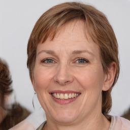 Joyful white adult female with medium  brown hair and brown eyes