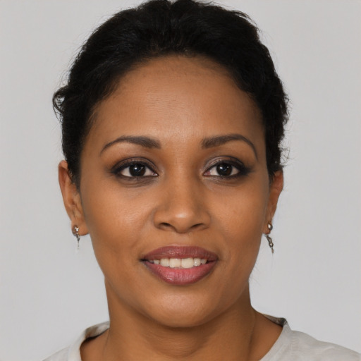 Joyful latino young-adult female with short  black hair and brown eyes