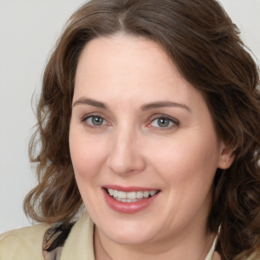 Joyful white adult female with medium  brown hair and brown eyes