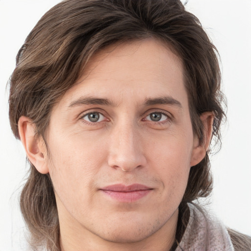 Joyful white young-adult male with medium  brown hair and grey eyes