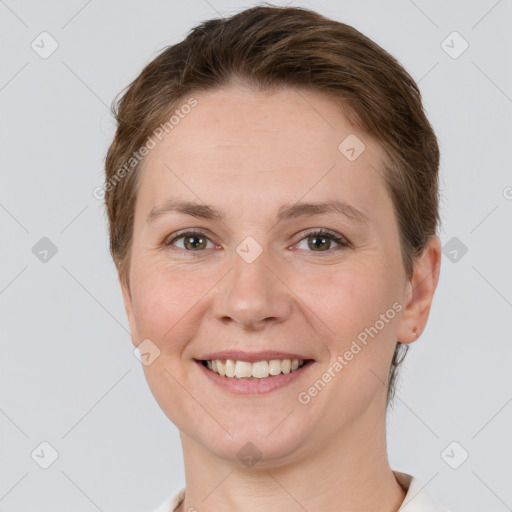 Joyful white young-adult female with short  brown hair and grey eyes