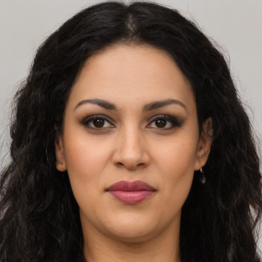 Joyful latino young-adult female with long  black hair and brown eyes