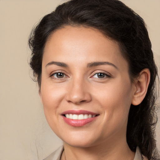 Joyful white young-adult female with long  brown hair and brown eyes