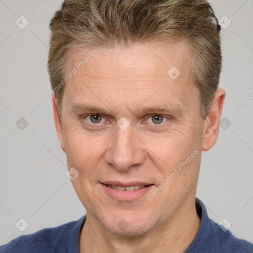 Joyful white adult male with short  brown hair and grey eyes