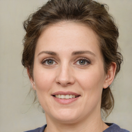 Joyful white young-adult female with medium  brown hair and green eyes