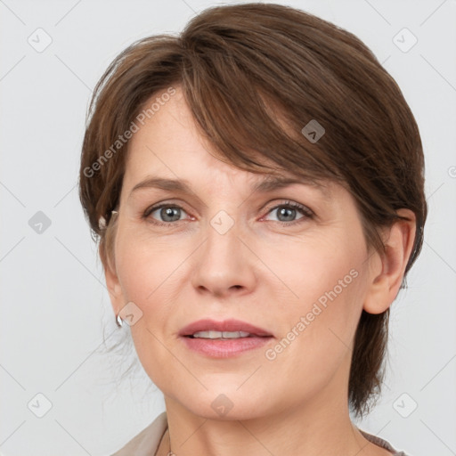 Joyful white adult female with medium  brown hair and grey eyes