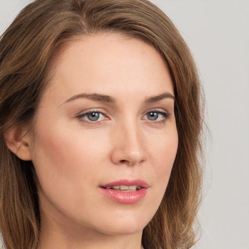 Joyful white young-adult female with long  brown hair and green eyes