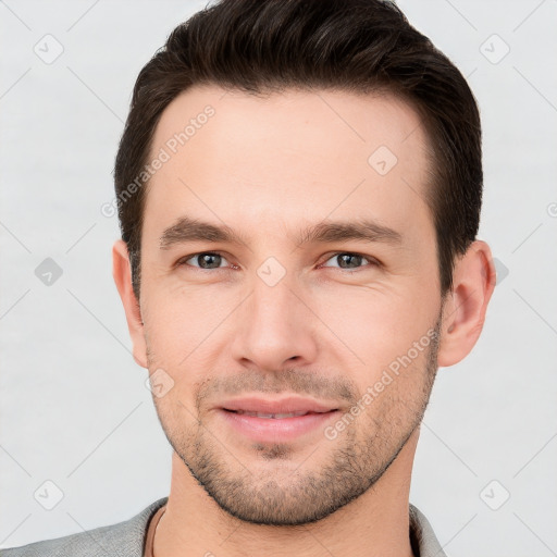 Joyful white young-adult male with short  brown hair and brown eyes